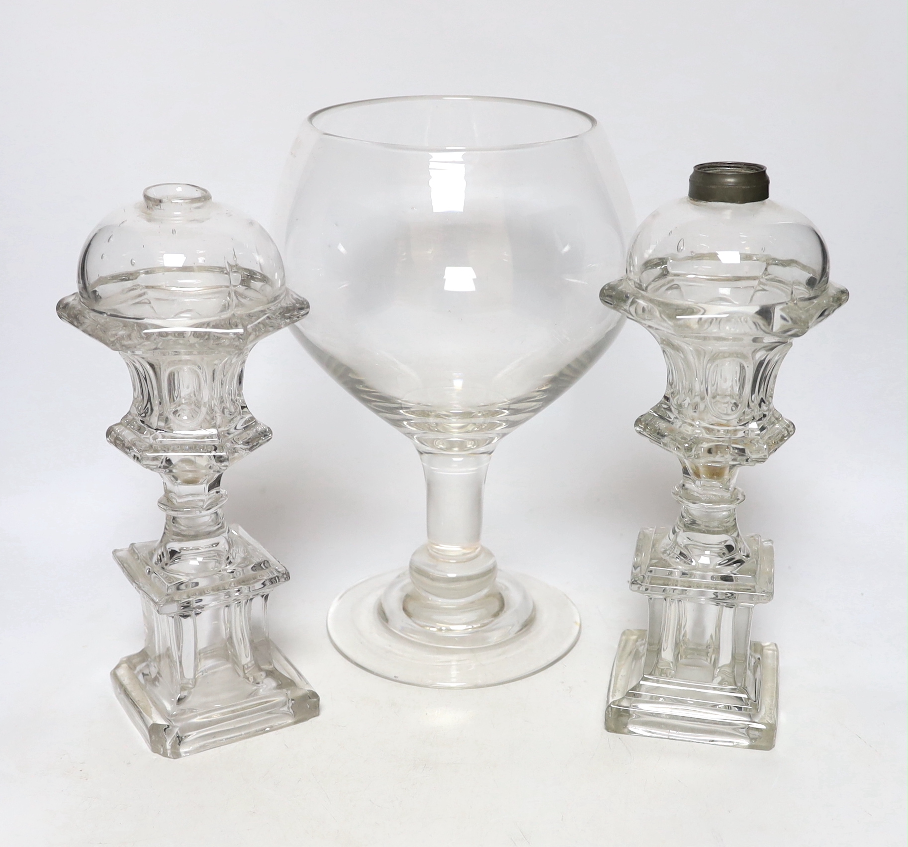 A pair of Victorian glass lamp bases and a goblet vase, largest 30cm